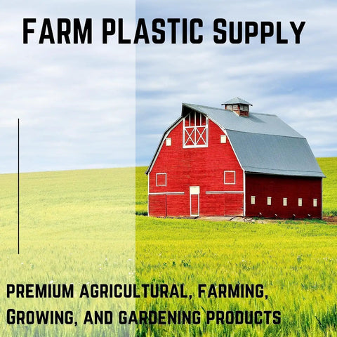Red barn surrounded by green fields under clear sky, promoting Farm Plastic Supply's agricultural and farming products