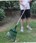 Man raking leaves with Heavy Duty 11-Tooth Carbon Steel Rake Head 10 Inch Wide Replacement With Pre Drilled Holes in garden