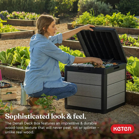 Woman using Denali 30 Gallon Resin Outdoor Storage Box And Patio Furniture Side Table For Pool And Garden Accessories Gray And Black All Weather Durable Resin With Wood Look Finish in a garden.