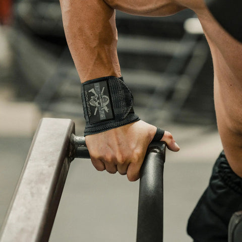 Person using 18 Inch Heavy Duty Wrist Wraps For Weightlifting And Powerlifting With Ultra Strong Support For Bench Press, Deadlifts, Curls, CrossFit, And General Gym Workouts For Men during exercise