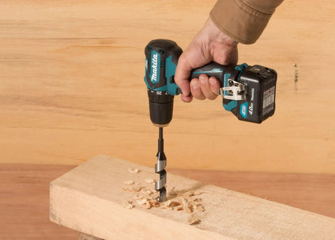 Badass 12v Max Lithium Ion Cxt Brushless Drill Driver Featuring Electric Brake And Bright Led Lamp Keyless Chuck Compact Heavy Duty Cordless Tool Built Different For Real World Projects drilling into wood with spiral bit.