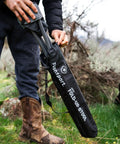 Person placing Apex Fold-Up Stool G-140 Black Grey Ultra Portable Camp Seat into carry bag outdoors