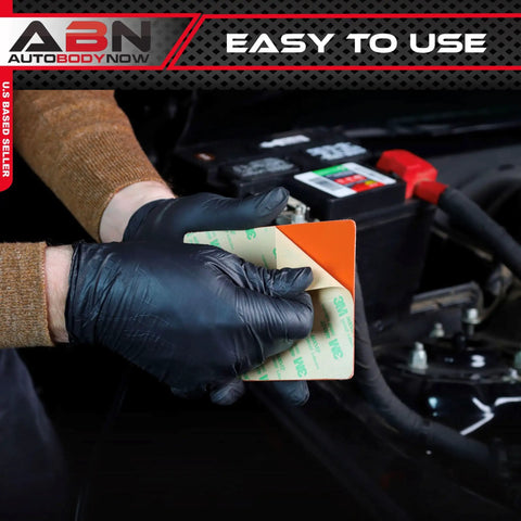 Person applying adhesive for Heavy Duty Silicone Car Battery And Engine Block Heater Pad With Quick Ice Melter Shield in vehicle.