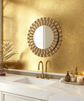 Dope Gold Peel And Stick Wallpaper Thick Metallic Wallcovering covering a bathroom wall with a round decorative mirror.