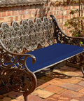 Outdoor Bench Cushions 48 By 18 Inch Thick Waterproof Porch Swing Cushions With Ties Navy For Patio Furniture UV FadeShield Tech 5 Year Colorfast Weatherproof And Durable installed on iron bench