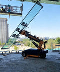 Pro Grade Glass Vacuum Lifter With Wireless Remote Control delivering heavy lifting for window installation onsite.