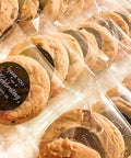 Cookies in Clear Self Sealing Cookie Bags 5x6 Inch 100 Pack Sweet Gift Packaging For Cookies Treats Candy Party Favors Cellophane Bags With Strong Self Adhesive Closure 1.4 Mil Thick 13x15 Cm displayed on table