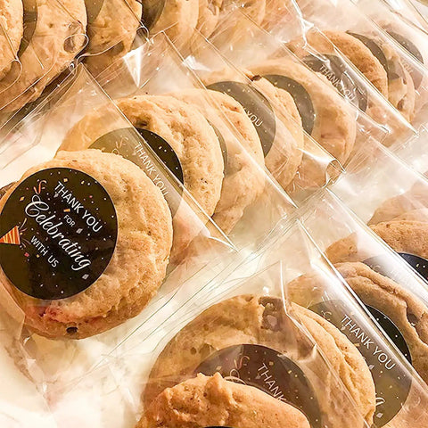 Cookies in Clear Self Sealing Cookie Bags 5x6 Inch 100 Pack Sweet Gift Packaging For Cookies Treats Candy Party Favors Cellophane Bags With Strong Self Adhesive Closure 1.4 Mil Thick 13x15 Cm displayed on table