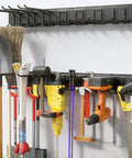 Heavy Duty Wall Mount Garage Tool Organizer With Adjustable Sliding Hooks, 500 Lbs Capacity, Anti Rust Steel Rack For Hanging Rake Broom Mower Snowboard And More, Built Tough For Garage And Workshop, holding various tools on wall.