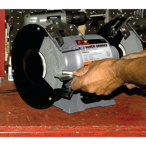 Heavy Duty 8 Inch Bench Grinder With A 0.75 HP Motor, Cast Iron Housing, ball bearings, being adjusted on workbench