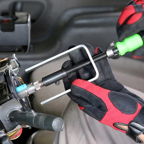 Mechanic using Steering Wheel Lock Plate Remover Tool With Reversible Adapter For 9/16-18 And M14-1.5 Threads on car steering column