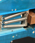 Hella Solid Floating Tremolo Setup Blocks For Quick Guitar Tuning And Deck Leveling Zero Hassle Premium Luthier Gear Strat Style Bridge Stabilizer Wedges, close-up of mahogany wedge and springs in a guitar tremolo cavity.