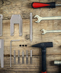 Pinion Gear Puller Remover Set For RC Motors And Vehicle Models With Five Pins on wooden surface, includes tools and accessories.