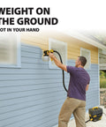 Man using FlexiO 890 HVLP Paint Sprayer Shoots Unthinned Latex smooth on exterior siding with light gray and yellow walls.