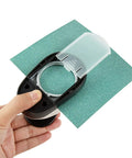Hand holding a 2 Inch Circle Hole Punch Cutter for Paper Circles Craft Punch 50.8Mm Round Cutter for scrapbooking, cutting green paper