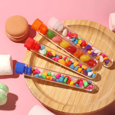 40 Pack Plastic Test Tubes With Rack And Color Coded Caps 12Ml 16X100Mm Polystyrene Clear Durable Lab Tubes For Science Class And Home Experiments Nerd Friendly Lab Kit filled with colorful candies on a wooden plate