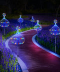Lit Solar Firework Garden Lights 5 Pack 120 LED Decorative Stakes With Remote illuminating a garden pathway at night