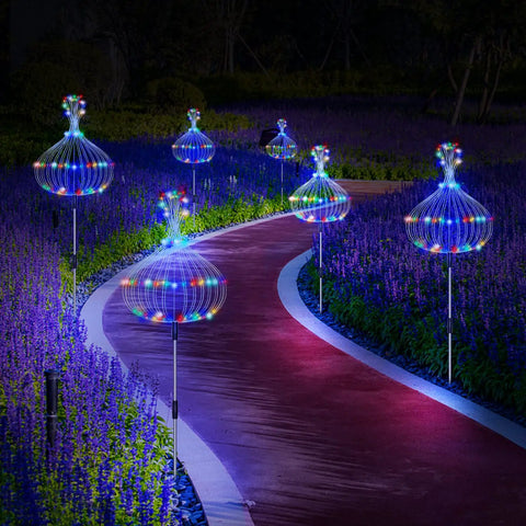 Lit Solar Firework Garden Lights 5 Pack 120 LED Decorative Stakes With Remote illuminating a garden pathway at night