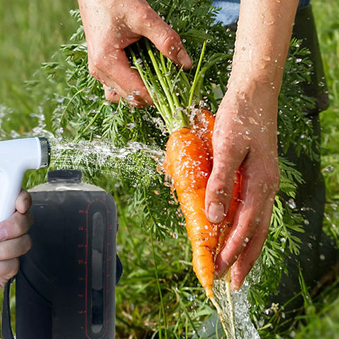 Person washes carrots using Foldable 12L Solar Heated Camping Shower Kit With Removable Hose And Showerhead For Beach Trips Hiking Travel
