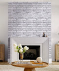 3D Faux Brick Peel And Stick Tiles Set Of 10 Small 11.8 By 11.8 Inch PVC Wall Panels in Warm White on fireplace wall