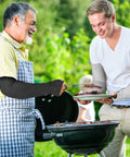 Two people grilling wearing 5 Pack Cut Resistant Arm Sleeves With Thumb Hole Guards For Gardening, Farming, Welding And Pet Grooming.