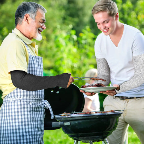 Two people grilling wearing 5 Pack Cut Resistant Arm Sleeves With Thumb Hole Guards For Gardening, Farming, Welding And Pet Grooming.