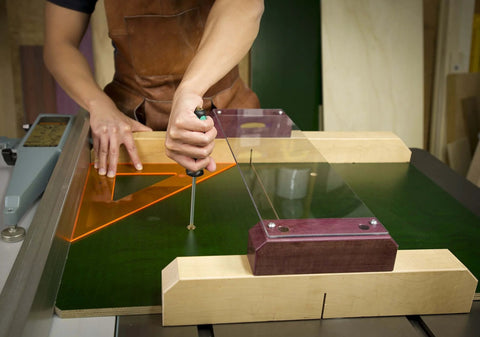 Using ZeroPlay Miter Bars 2-Pack with MatchFit Jig Handle on a table saw sled, demonstrating top-down mounting system