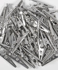 50 Pack 28mm Metal Alligator Clips For Lab And Battery Testing, 1.1 Inch Crocodile Clip Clamps, metal clips scattered on surface