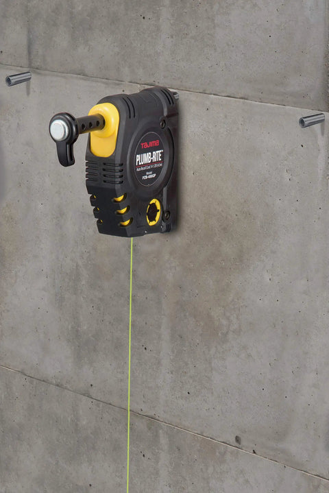 Magnetic Plumb Bob Setter 14 Ounce With Quick Stabilization Self Retracting 14.5 Foot Line attached to concrete wall