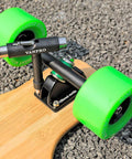 Close-up of skateboard with green wheels and All In One Skate Tool For Quick Repairs On Skateboards Longboards Penny Boards And Roller Skates Snow Black Finish Perfect For Installation And Maintenance Of Trucks Bearings And Hardware