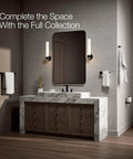 Parallel 18 Inch Towel Bar Matte Black Sleek Modern Bathroom Hardware in rustic bathroom with marble counter and wall sconces.