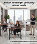 Farexon Electric Standing Desk Adjustable Height Black Brown Wood Grain Surface With Power Outlets, Wheels, And Mouse Pad For Home Office Gaming Computer Workstation Ergonomic Lift Table in modern office setting.
