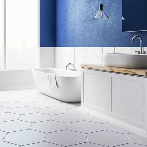 Modern bathroom with hexagonal tiles, featuring Spectralock 1 Pre Mixed Grout In Light Pewter, Stain Proof Color Lock, white tub and sink.