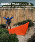 Camper setting up UltraLight 11 Ft Hammock Shelter With Net And Rain Fly Tarp Four In One Camping Tent for hiking without trees.