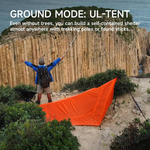 Camper setting up UltraLight 11 Ft Hammock Shelter With Net And Rain Fly Tarp Four In One Camping Tent for hiking without trees.