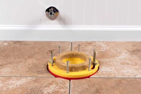 Toilet Flange Extender Kit Set Rite One Quarter To One And Five Eighths Inch Red And Yellow installed on tiled floor.