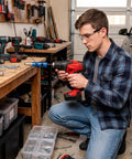 Man using Attachment Kit For Drill With High Torque Pop Rivet Head in garage setting for metal fastening.