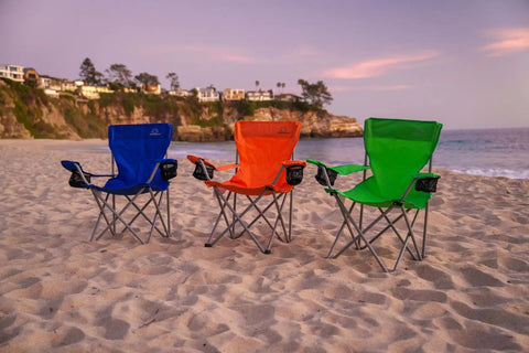 Three Anytime Chair For Camping And Outdoors, Foldable And Portable Outdoor Folding Chairs with carry bags on a beach, blue, orange, and green.