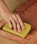 Hand using Very Fine 220 Grit Dual Angle Sanding Sponge 3 By 5 By 1 Inches for wood surface