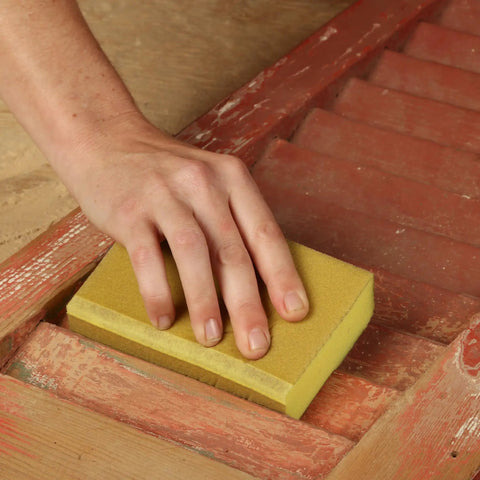 Hand using Very Fine 220 Grit Dual Angle Sanding Sponge 3 By 5 By 1 Inches for wood surface