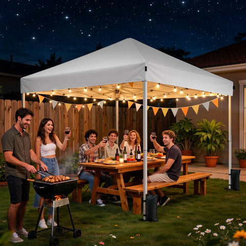 10x10 Pop Up Canopy Tent With Instant One Button Setup Carry Bag Four Sandbags And Eight Stakes Lightweight Outdoor Shade For Parties, Camping, Markets And Events White in a backyard at night with people enjoying a meal.