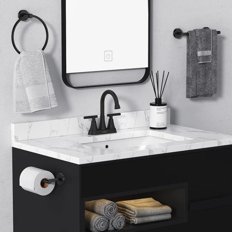 Installed matte black 4-inch centerset bathroom sink faucet with two handles; includes pop-up drain and supply hoses.