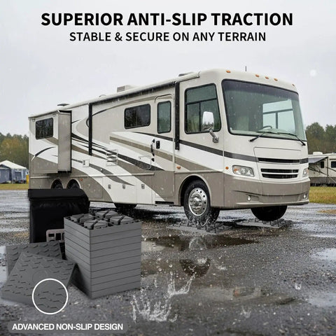 Rock Solid Interlocking RV Leveling Blocks 12 Pack Adjustable Stackable Wheel Supports For Campers Travel Trailers Fifth Wheel No Sweat Setup Top Shelf Grey near RV on wet terrain.