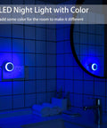 Blue LED Night Light Plug In Dusk To Dawn Sensor Small Round Nightlight in bathroom scene with blue glow on tiled wall
