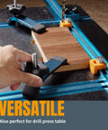 Beefy T Track Hold Down Clamp Set in use on drill press with wood, blue black finish, ergonomic grips, bolts, washers, star knobs