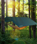 Waterproof Camping Tarp 10x10 Feet Rain Fly Ultralight Portable With UV Protection set up over a hammock in a forest.