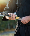 Man drawing Unsharpened Stainless Steel Wakizashi Iaito For Iaido Training 21 Inch Practice Sword from its bamboo sheath