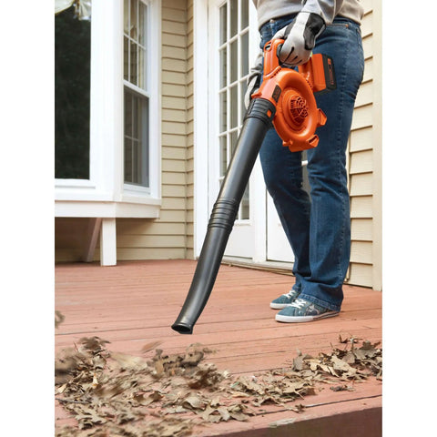 Person using Cordless Leaf Blower With Battery And Charger, 40V Max PowerCommand on deck to clear leaves, 120 MPH peak air speed.