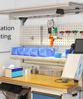 Workstation with tool pegboard, blue storage bins, and mounted tools for convenient access in an organized work environment.