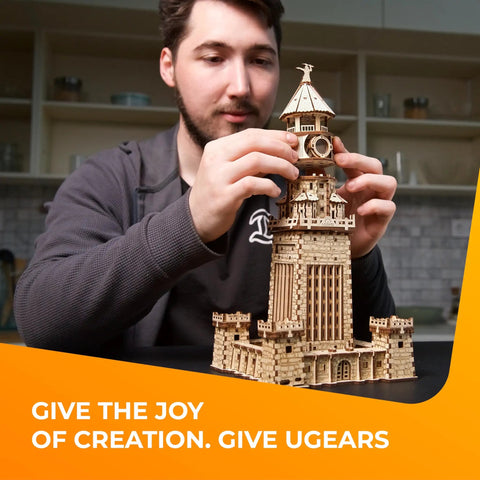 Man assembling Lighthouse Of Alexandria 3D Wooden Puzzle Kit For Adults With LED Night Light, DIY Model Building Hobby Set, Ancient World Landmark, Brain Teaser, Creative Home Decor And Conversation Starter by hand
